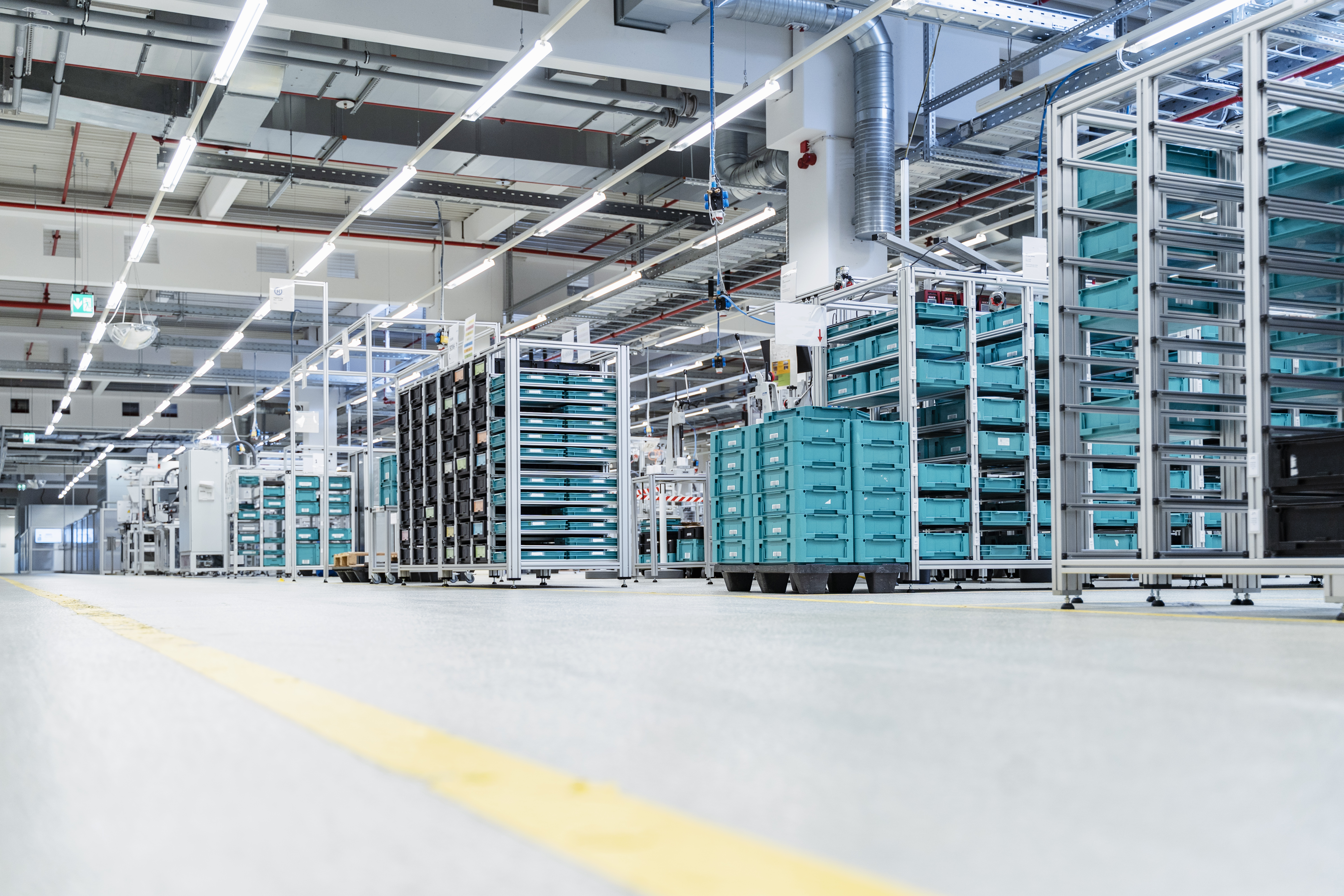 Stacked containers inside modern factory warehouse, Stuttgart, Germany